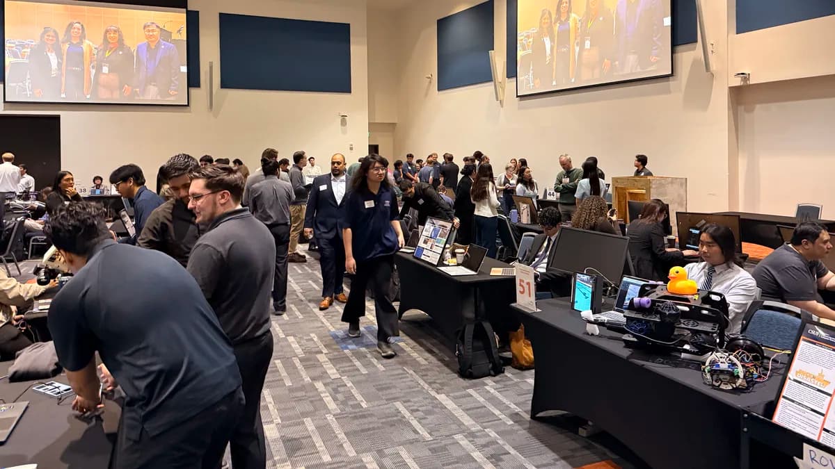 The ECS Innovation Expo floor at Cal State Fullerton: project tables, attendees engaging with student teams, and large screens on the back wall